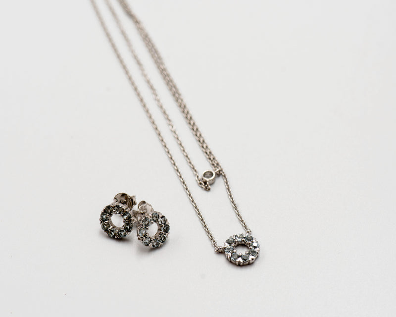 127 Set Chain and Earring Elegant silver round earrings and chain set, featuring a combination round pendant with March blue topaz stones.