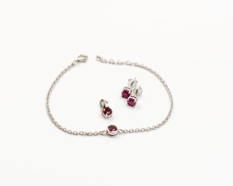 140 Set Elegant silver 3-piece set, featuring round earrings with 50mm January garnet stones, a matching pendant, and a bracelet with garnet stones.