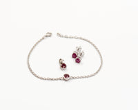 146 Elegant silver 3-piece set, featuring round earrings with 50mm July ruby stones, a matching pendant, and a bracelet with ruby stones.
