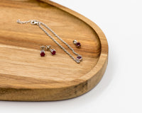 146 Elegant silver 3-piece set, featuring round earrings with 50mm July ruby stones, a matching pendant, and a bracelet with ruby stones.