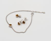 150 Elegant silver 3-piece set, featuring round earrings with 50mm November citrine stones, a matching pendant, and a bracelet with citrine stones.