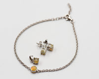 149 Elegant silver 3-piece set, featuring round earrings with 50mm October opal stones, a matching pendant, and a bracelet with opal stones.