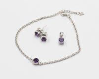 151 Elegant silver 3-piece set, featuring round earrings with 50mm December tanzanite stones, a matching pendant, and a bracelet with tanzanite stones.