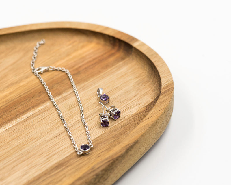 151 Elegant silver 3-piece set, featuring round earrings with 50mm December tanzanite stones, a matching pendant, and a bracelet with tanzanite stones.