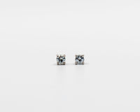 114 Earring Elegant silver 3mm stud earrings featuring a March blue topaz birthstone.