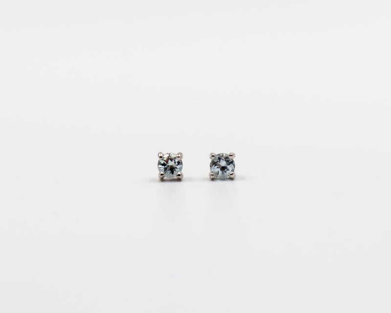114 Earring Elegant silver 3mm stud earrings featuring a March blue topaz birthstone.