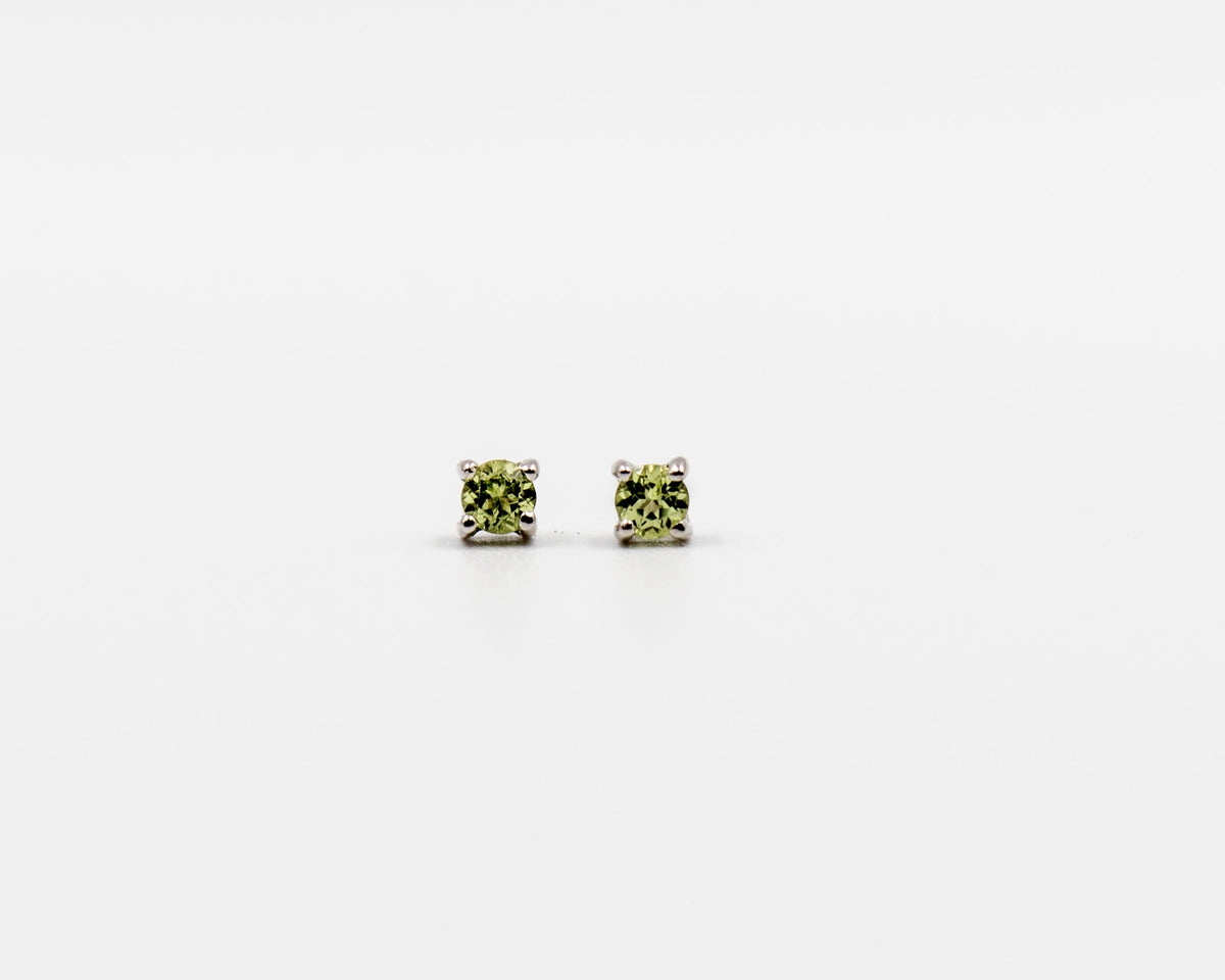 119 Earrings Elegant silver 3mm stud earrings featuring an August peridot birthstone.