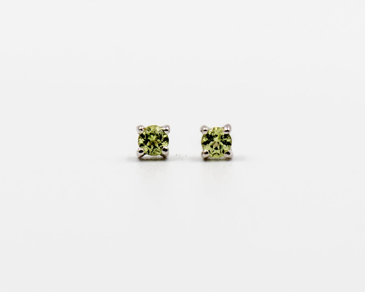 119 Earrings Elegant silver 3mm stud earrings featuring an August peridot birthstone.