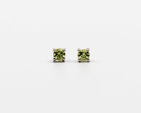 119 Earrings Elegant silver 3mm stud earrings featuring an August peridot birthstone.